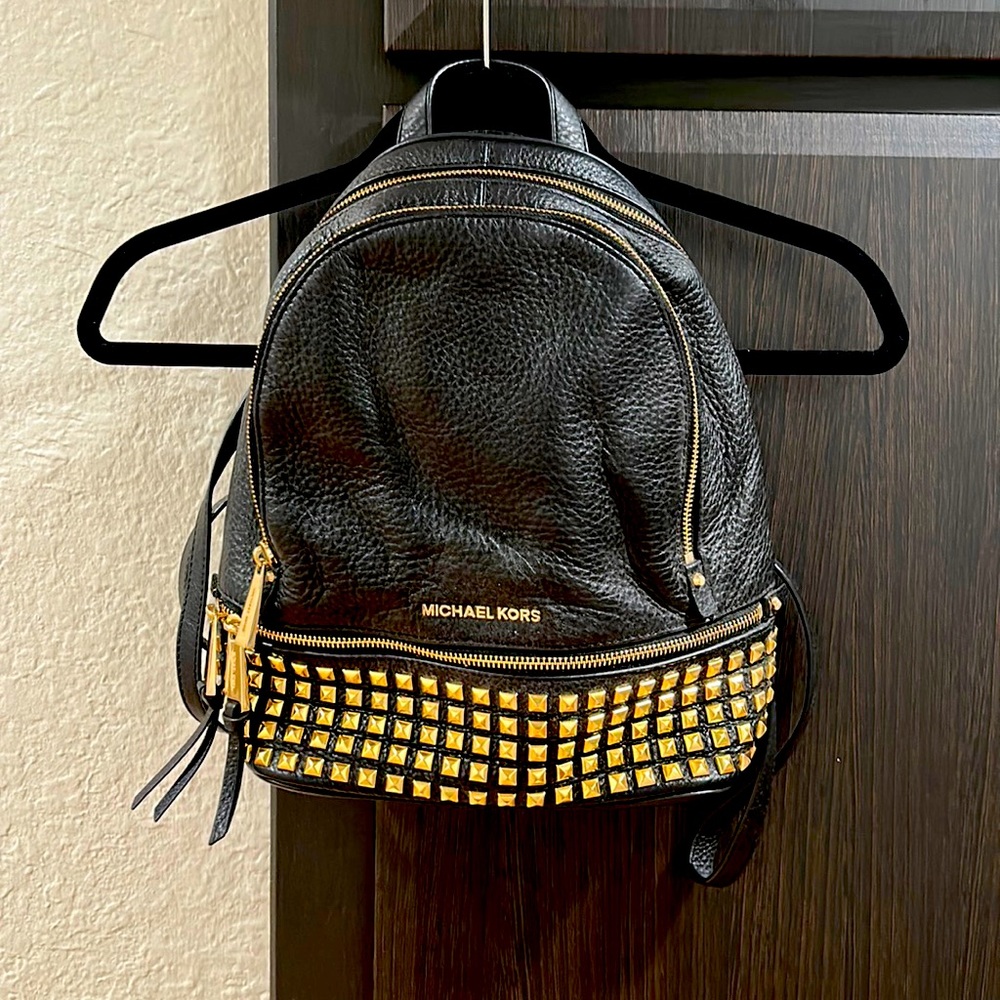 Black backpack with gold zippers and studs from Michael Kors